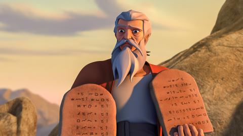 Moses is holding the 10 commandments written on the stone